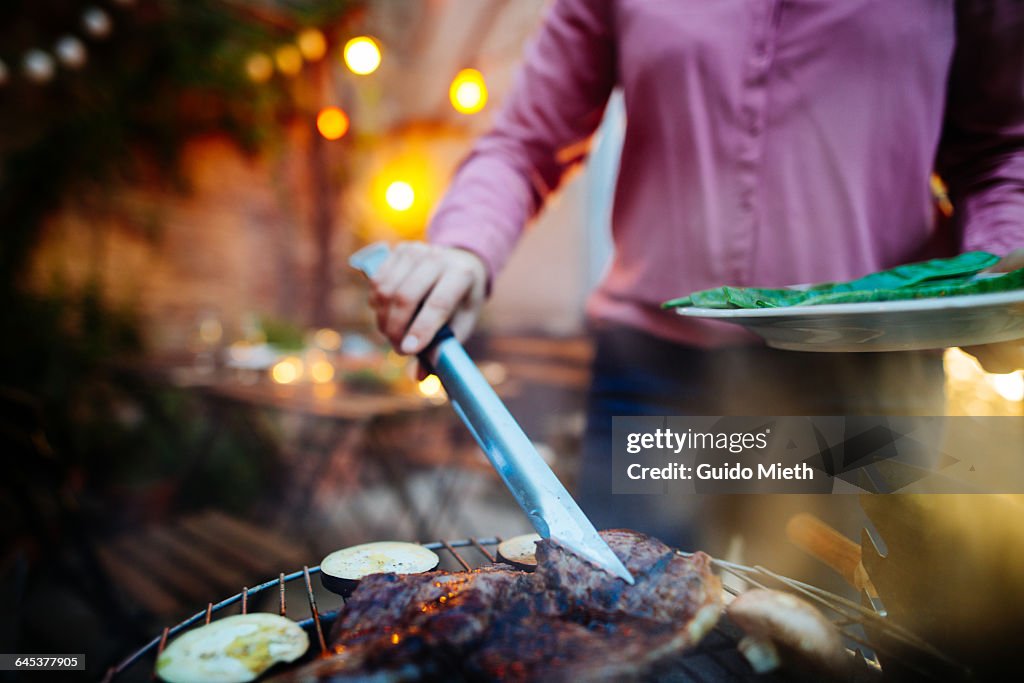 Woman having a barbecue outdoor.