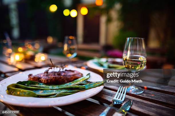 romantic dinner outdoor. - plate with cutlery foto e immagini stock