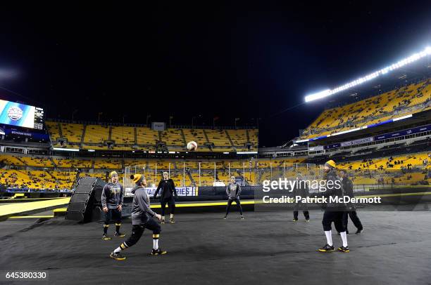 Chris Kunitz of the Pittsburgh Penguins, second from left, looks to play the ball as he and teammates warm up prior to the 2017 Coors Light NHL...