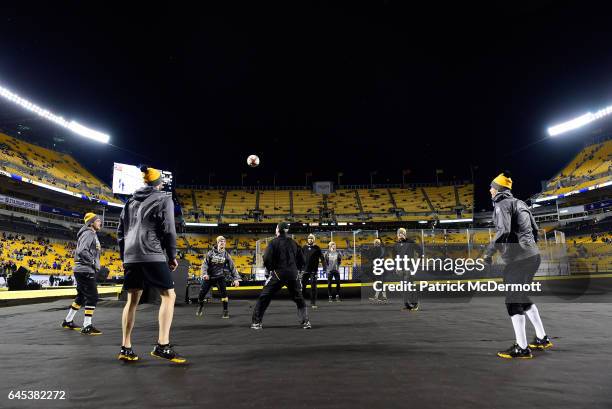 Sidney Crosby of the Pittsburgh Penguins waits to play the ball as Steve Oleksy, Chris Kunitz, Nick Bonino, Patric Hornqvist and teammates look on...