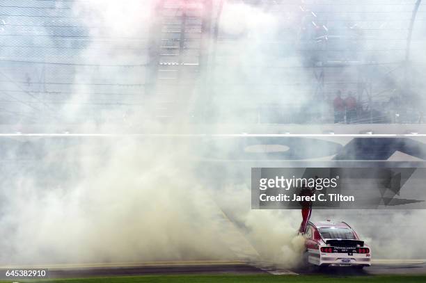 Ryan Reed, driver of the Lilly Diabetes Ford, celebrates winning the NASCAR XFINITY Series PowerShares QQQ 300 at Daytona International Speedway on...