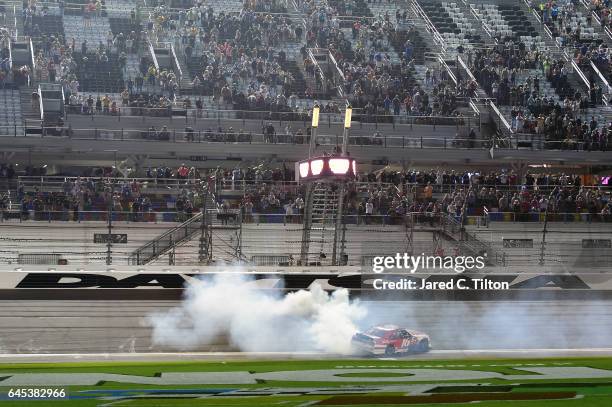 Ryan Reed, driver of the Lilly Diabetes Ford, celebrates with a burnout after winning the NASCAR XFINITY Series PowerShares QQQ 300 at Daytona...