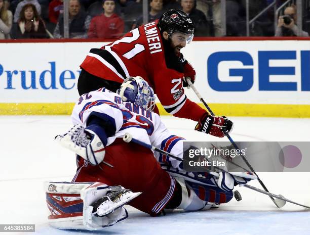 Antti Raanta of the New York Rangers stops a shot by Kyle Palmieri of the New Jersey Devils in the overtime period on February 25, 2017 at Prudential...