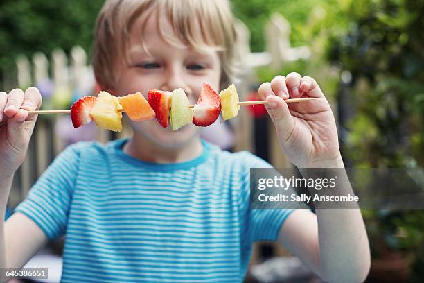 child making a fruit kebab - skewer stock pictures, royalty-free photos & images