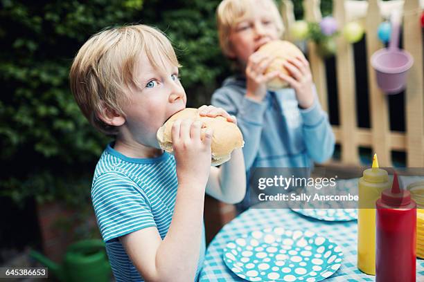 children at a family barbecue - burger on grill photos et images de collection