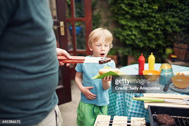 family barbecue - man offering bread stock pictures, royalty-free photos & images