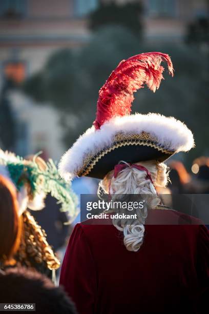 masquerade man with feathered hat - velvet hat stock pictures, royalty-free photos & images