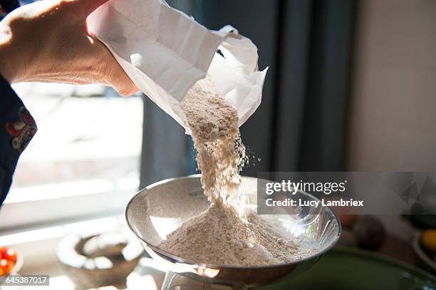 making bread, weighing flour - flour foto e immagini stock