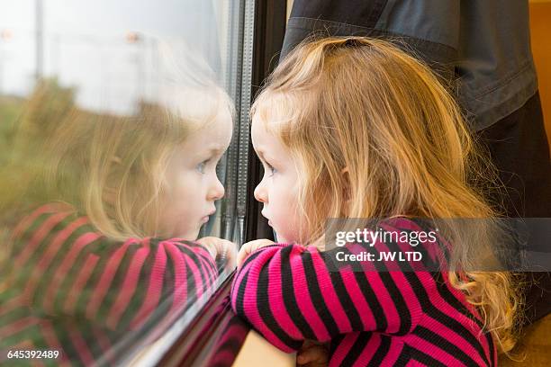 girl 3-4 years looking out of train window - cute kids stock pictures, royalty-free photos & images