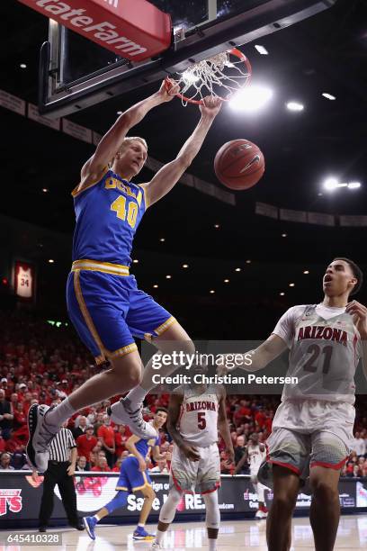Thomas Welsh of the UCLA Bruins slam dunks the ball over Chance Comanche of the Arizona Wildcats during the second half of the college basketball...