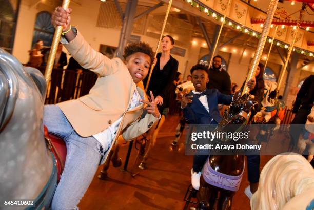 Actors Jaden Piner and Alex R. Hibbert ride the carousel at the 2017 Film Independent Spirit Awards at the Santa Monica Pier on February 25, 2017 in...