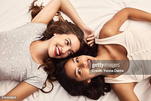 two young woman on a bed - friends women makeup stock pictures, royalty-free photos & images