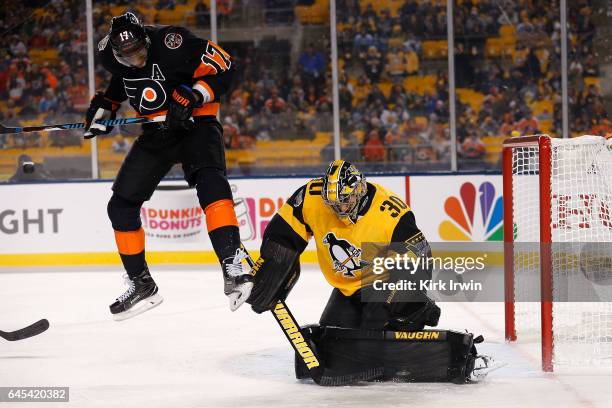 Matt Murray of the Pittsburgh Penguins makes a save as Wayne Simmonds of the Philadelphia Flyers applies a screen during the third period of the game...