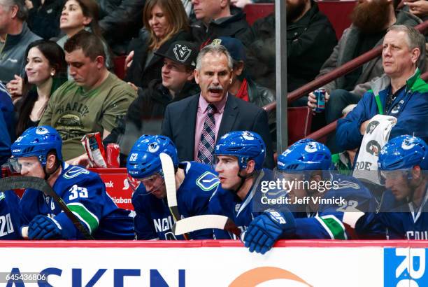 Head coach Willie Desjardins of the Vancouver Canucks looks on from the bench during their NHL game against the San Jose Sharks at Rogers Arena...