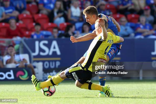 Aleksandr Kokko of the Jets is tackled by Jacob Poscoliero of the Mariners during the round 21 A-League match between the Newcastle Jets and the...