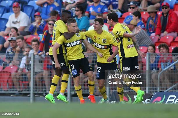 Scott Galloway of the Mariners is congratulated by team mates after scoring a goal during the round 21 A-League match between the Newcastle Jets and...