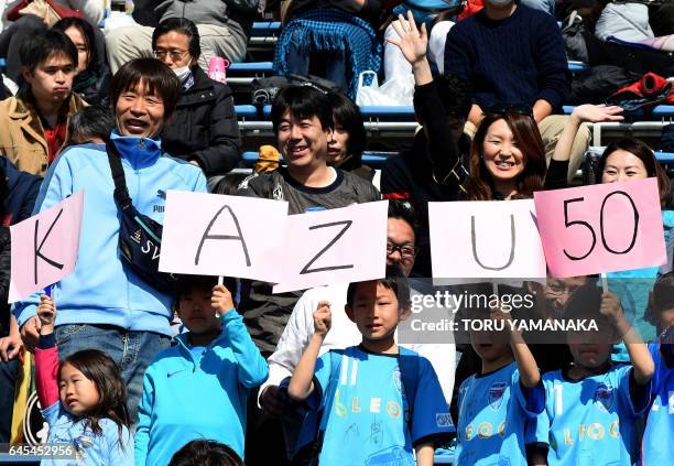 Fans cheer former Japan striker Kazuyoshi Miura of the J-League second-tier club Yokohama FC before the opening match of 2017 season against...