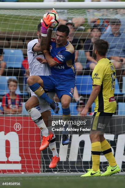 Steven Ugarkovic of the Jets receives a yellow card for colliding with Paul Izzo of the Mariners during the round 21 A-League match between the...