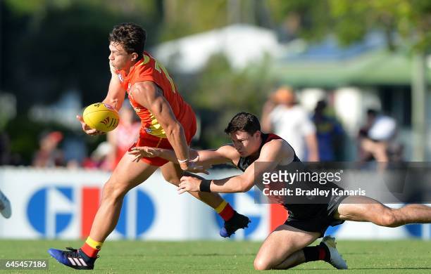Jesse Lonergan of the Suns attempts to break away from the defence during the JLT Community Series AFL match between the Gold Coast Suns and the...