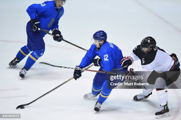 Alexey Antsiferov of Kazakhstan and Ryo Hashiba of Japan compete in the men's ice hockey match between Japan and Kazakhstan on day nine of the 2017...