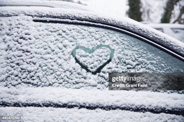 heart shape on car window. - winter car window stock pictures, royalty-free photos & images