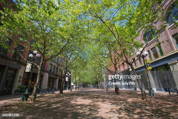 spring sunshine on occidental avenue, pioneer square - seattle in the spring stock pictures, royalty-free photos & images