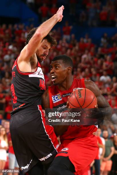 Casey Prather of the Wildcats drives to the basket against Kevin White of the Hawks during game one of the NBL Grand Final series between the Perth...