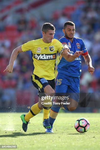 Nick Montgomery of the Mariners contests the ball with Andrew Nabbout of the Jets during the round 21 A-League match between the Newcastle Jets and...