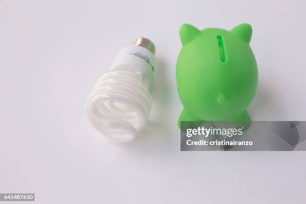 green piggy bank - energy bill stock pictures, royalty-free photos & images