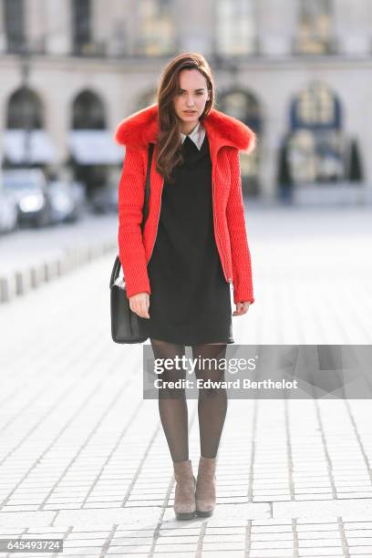 Ophelie Duvillard, model and fashion blogger, wears a Rue des Abesses black dress with a white collar, a Fusalp red winter coat with fur, Hogan brown...