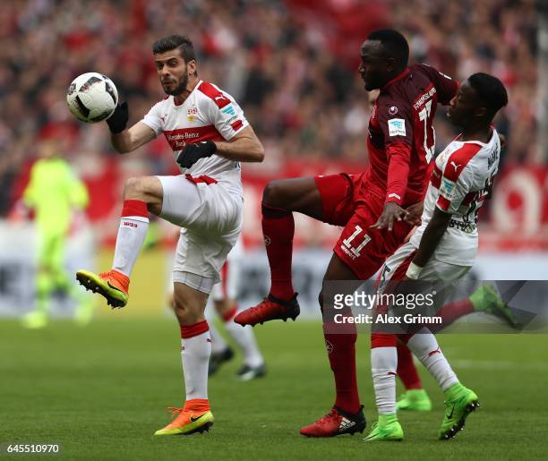 Jacques Zoua Daogari of Kaiserslautern is challenged by Emiliano Adriano Insa and Carlos Manuel Cardoso Mane of Stuttgart during the Second...