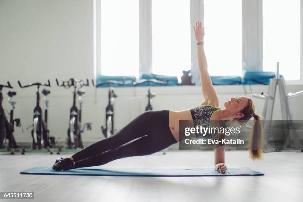 woman working out - side plank pose stock pictures, royalty-free photos & images