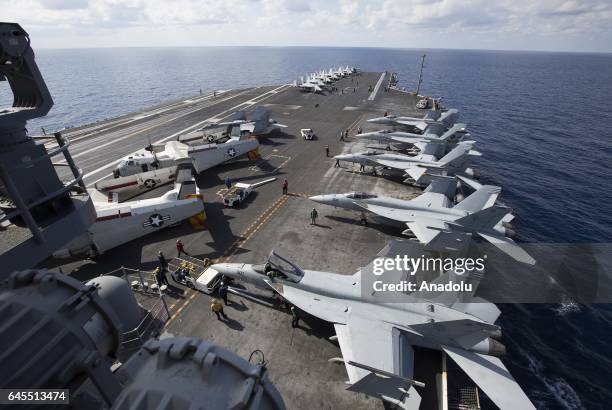 Super Hornet and F/A-18 Hornet warplanes are seen on the flight deck of US aircraft carrier USS George Washington during its mission in the eastern...