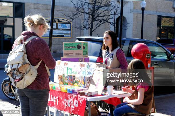 Molly Sheridan age 13, and her sister Edie, age 5, sell Girl Scout cookies in Chicago on February 19, 2017. On a sunny Sunday afternoon, Molly...