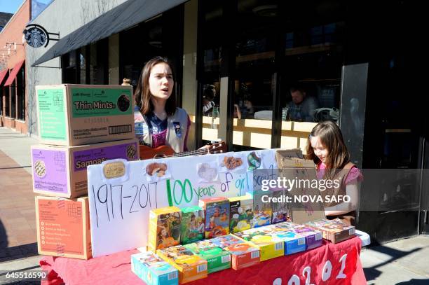 Molly Sheridan age 13, sings with her ukulele as she and her sister Edie age 5, sell Girl Scout cookies in Chicago on February 19, 2017. On a sunny...