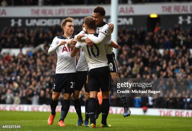 Dele Alli of Tottenham Hotspur celebrates scoring his teams fourth goal with teammates Harry Kane and Christian Eriksen during the Premier League...
