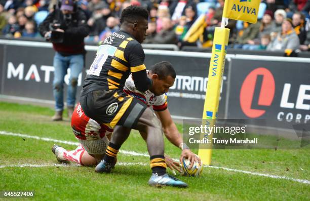 Christian Wade of Wasps tackles David Halaifonua of Gloucester Rugby as he scores a try during the Aviva Premiership match between Wasps and...
