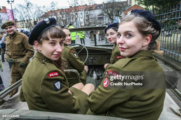 Young female history reenactors dressed as Cursed soldiers are seen in the Jeep Willys MB car during the Cursed soldiers Day parade on 26 February...