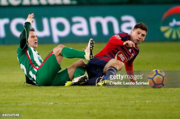 Tamas Hajnal of Ferencvarosi TC fights for the ball on the ground with Mate Patkai of Videoton FC during the Hungarian OTP Bank Liga match between...