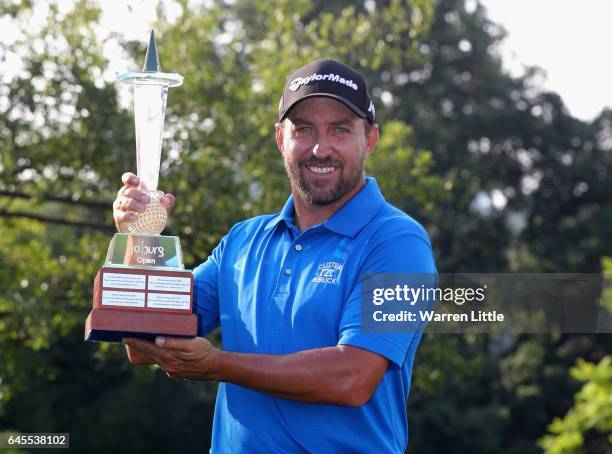 Darren Fichardt of South Africa poses with the trophy after winning the Joburg Open at Royal Johannesburg and Kensington Golf Club on February 26,...