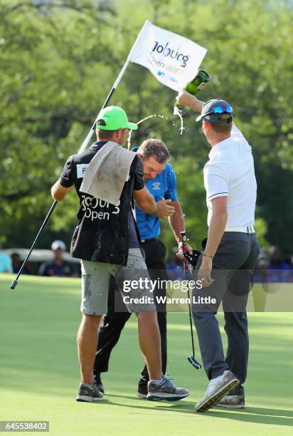 Darren Fichardt of South Africa is congratulated by fellow South African golfer Brandon Stone after winning the Joburg Open at Royal Johannesburg and...