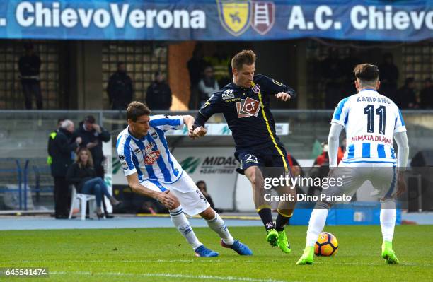 Valter Birsa of ChievoVerona competes with Cristiano Biraghi of Pescara Calcio during the Serie A match between AC ChievoVerona and Pescara Calcio at...