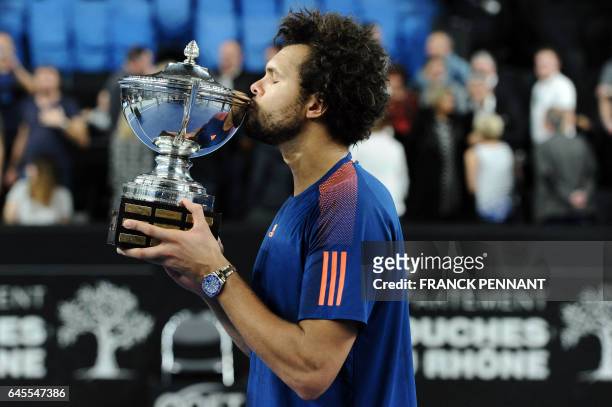 France's Jo-Wilfried Tsonga celebrates with his trophy after winning his ATP Marseille Open 13 tennis final match against France's Lucas Pouille on...