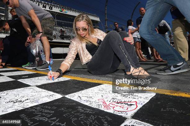 Race fan signs the start-finish line prior to the 59th Annual DAYTONA 500 at Daytona International Speedway on February 26, 2017 in Daytona Beach,...