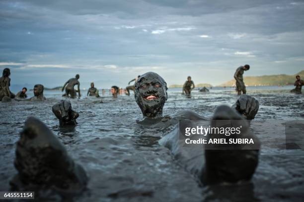 Revellers take part in the 31st carnival of the "Bloco da Lama" mud carnival band in Paraty, about 250km south of Rio de Janeiro, Brazil, on February...