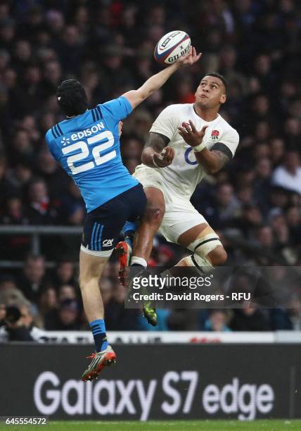 Nathan Hughes of England and Carlo Canna of Italy compete for a high ball during the RBS Six Nations match between England and Italy at Twickenham...