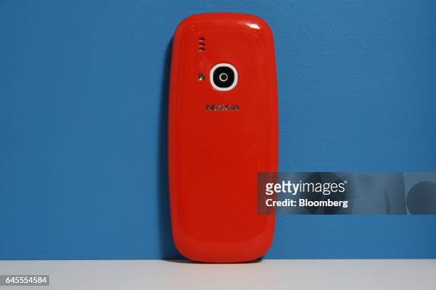The camera sits on the reverse side of the new Nokia 3310 mobile phone, developed by HMD Global OY, in warm red, as it is displayed during a product...