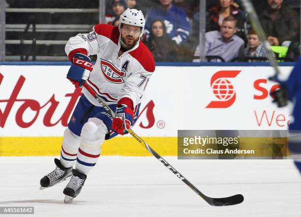 Andrei Markov of the Montreal Canadiens fires a pass up ice against the Toronto Maple Leafs during an NHL game at the Air Canada Centre on February...