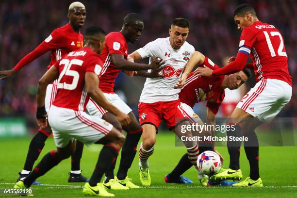 Dusan Tadic of Southampton is surrounded by the Manchester United defence during the EFL Cup Final match between Manchester United and Southampton at...