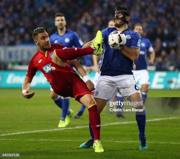 Ermin Bicakcic of Hoffenheim is challenged by Sead Kolasinac of Schalke during the Bundesliga match between FC Schalke 04 and TSG 1899 Hoffenheim at...